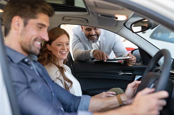 happy couple in new car